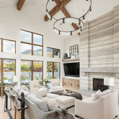 Living room - huge country open concept light wood floor and beige floor living room idea in Salt Lake City with white walls, a standard fireplace, a stone fireplace and a wall-mounted tv