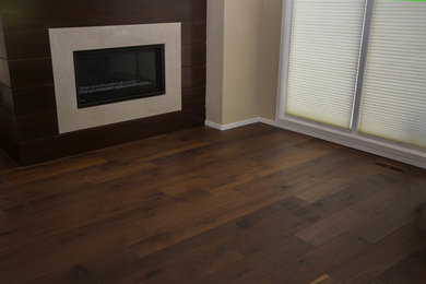 Example of a transitional dark wood floor living room design in Boise with a standard fireplace and a tile fireplace