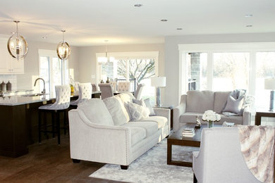 Example of a large trendy open concept laminate floor and brown floor living room design in Other with gray walls, a standard fireplace and a tile fireplace