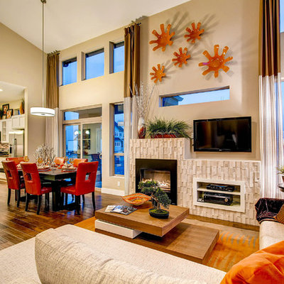 Example of a trendy open concept living room design in Denver with beige walls, a standard fireplace and a wall-mounted tv