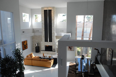 Photo of a modern living room in San Francisco with ceramic flooring, a standard fireplace, a tiled fireplace surround and white floors.
