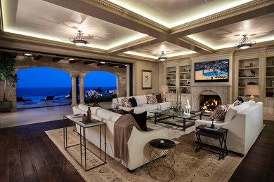 Inspiration for a huge timeless open concept medium tone wood floor living room remodel in Orange County with a standard fireplace, a concrete fireplace and a wall-mounted tv