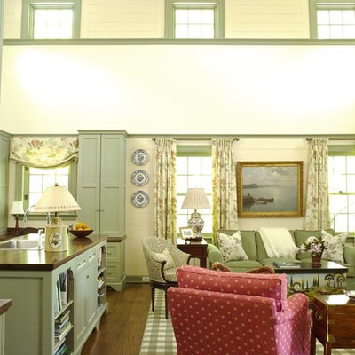 Example of a mid-sized cottage formal and loft-style dark wood floor living room design in New York with beige walls, a standard fireplace, a stone fireplace and a concealed tv