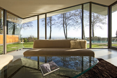 Cette photo montre un salon moderne de taille moyenne avec sol en béton ciré.