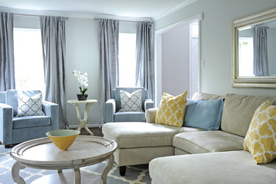 Example of a transitional living room design in DC Metro with blue walls