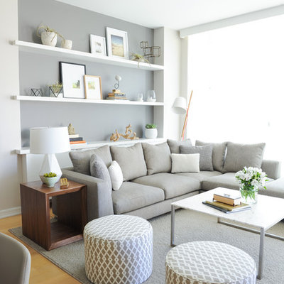 Example of a danish open concept light wood floor living room design in Vancouver with gray walls