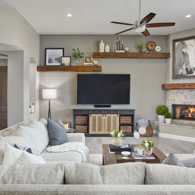 Living room - large transitional open concept porcelain tile and gray floor living room idea in Phoenix with gray walls, a corner fireplace, a stone fireplace and a wall-mounted tv