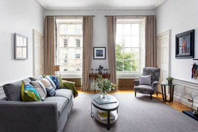 Inspiration for a traditional formal enclosed living room in Edinburgh with white walls, medium hardwood flooring and brown floors.