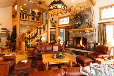 Design ideas for a large rustic open plan living room in Denver with a stone fireplace surround, no tv and medium hardwood flooring.