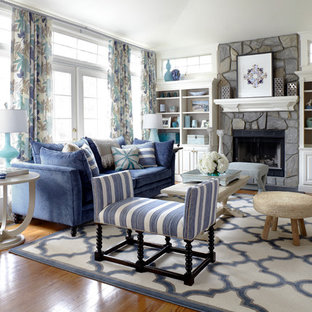 Living room - coastal formal medium tone wood floor living room idea in New York with white walls, a standard fireplace and a stone fireplace