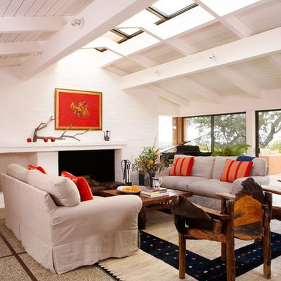 Inspiration for a coastal open concept concrete floor living room remodel in San Francisco with white walls, a standard fireplace and no tv