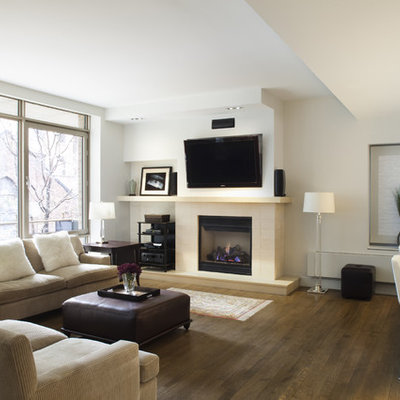 Trendy open concept dark wood floor living room photo in New York with white walls, a standard fireplace and a wall-mounted tv