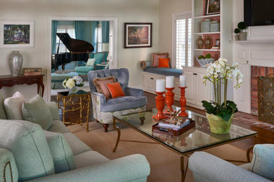 Mid-sized transitional enclosed medium tone wood floor living room photo in Orlando with a standard fireplace, a brick fireplace and white walls