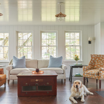 Example of a large country formal and open concept dark wood floor and brown floor living room design in New York with white walls and a wood stove