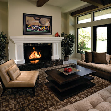 Family room that hides the TV over fireplace by VisionArt. Art rolls up and down