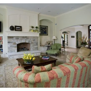 Family Room with Millmade Raised Hearth Stone Fireplace and Limestone Floors