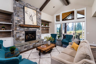 Mid-sized country formal and open concept medium tone wood floor and brown floor living room photo in Other with gray walls, a standard fireplace, a stone fireplace and no tv