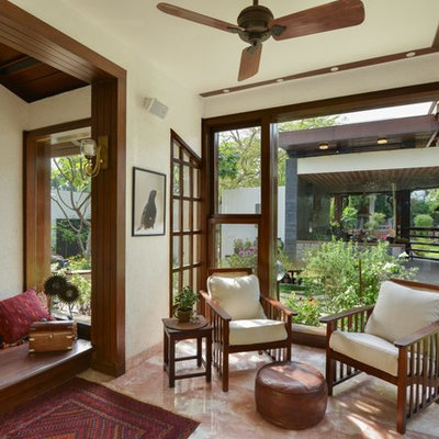 Inspiration for a small contemporary living room remodel in Delhi with white walls
