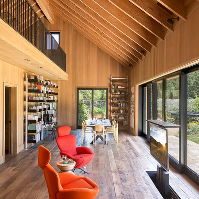 Example of a huge country open concept dark wood floor living room design in San Francisco with a concealed tv