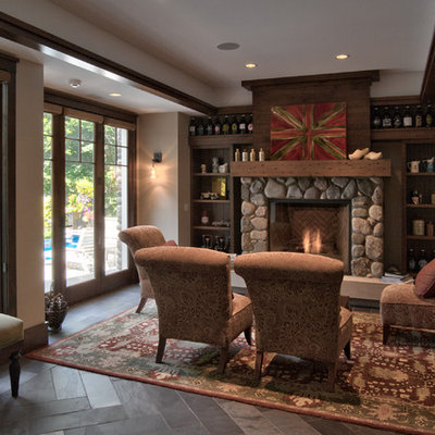 Example of a mid-sized farmhouse open concept slate floor and gray floor living room design in Minneapolis with beige walls, a standard fireplace, a stone fireplace and no tv
