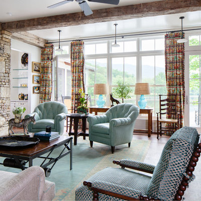 Farmhouse enclosed dark wood floor living room photo in Other with white walls, a standard fireplace and a stone fireplace