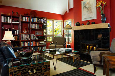 Foto de biblioteca en casa cerrada actual de tamaño medio con paredes rojas, moqueta, todas las chimeneas y marco de chimenea de baldosas y/o azulejos