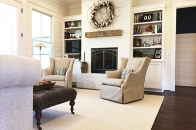Example of a mid-sized cottage open concept dark wood floor living room design in Other with a standard fireplace and a brick fireplace