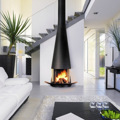 Trendy living room photo in Devon with white walls and a wood stove