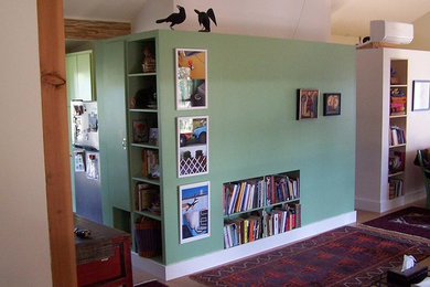 This is an example of a small contemporary living room in Austin with green walls.