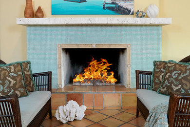 Inspiration for a large coastal open concept terra-cotta tile living room remodel in Miami with yellow walls, a standard fireplace, a stone fireplace and a media wall