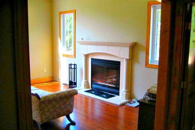 Example of a small classic formal and enclosed dark wood floor and brown floor living room design in Other with beige walls, a standard fireplace, a stone fireplace and no tv