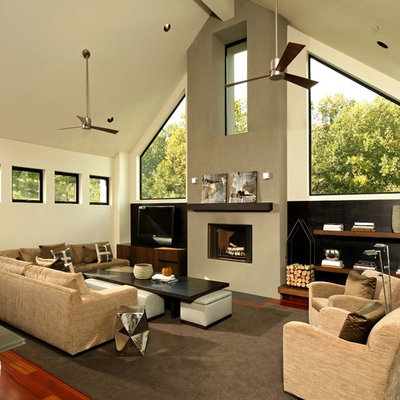Living room - mid-sized contemporary formal and open concept medium tone wood floor and brown floor living room idea in DC Metro with a tv stand, beige walls, a standard fireplace and a plaster fireplace