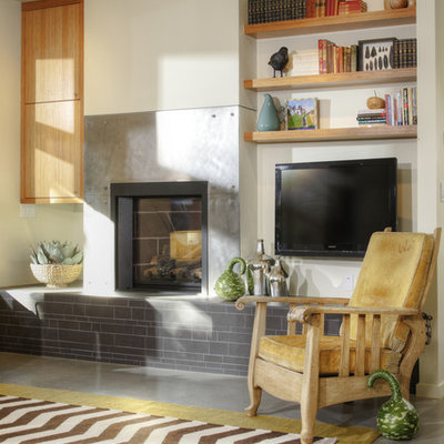 Living room library - mid-sized modern open concept concrete floor and gray floor living room library idea in Sacramento with white walls, a standard fireplace, a metal fireplace and a wall-mounted tv