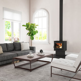 Mid-sized contemporary formal living room in Sydney with light hardwood floors, a wood stove, no tv and beige floor.
