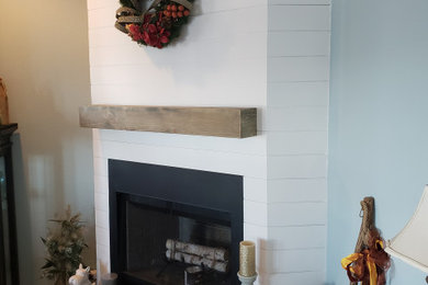Example of an open concept living room design in Houston with a corner fireplace and a shiplap fireplace