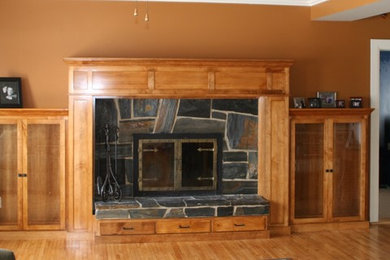 Large arts and crafts living room photo in Other with a standard fireplace and a wood fireplace surround
