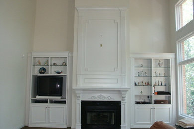Inspiration for a timeless living room remodel in Detroit with a wood fireplace surround and a tv stand