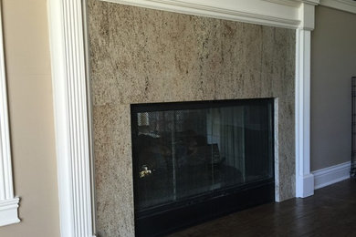 Example of a mid-sized classic dark wood floor living room design in Indianapolis with beige walls, a two-sided fireplace and a stone fireplace