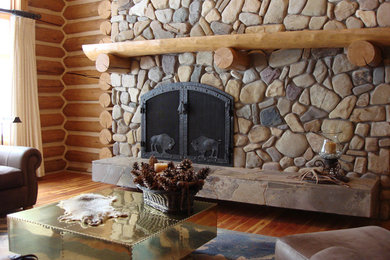 Diseño de salón para visitas abierto rústico de tamaño medio sin televisor con paredes marrones, suelo de madera en tonos medios, todas las chimeneas, marco de chimenea de piedra y suelo marrón