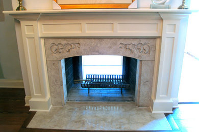 Example of a classic living room design in Charlotte with a concrete fireplace