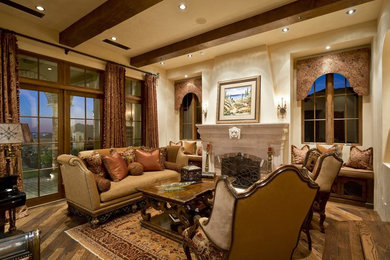 Large tuscan enclosed and formal medium tone wood floor and brown floor living room photo in Phoenix with beige walls, a standard fireplace and a brick fireplace