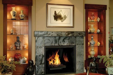 Example of a dark wood floor living room design in New York with beige walls, a standard fireplace and a stone fireplace