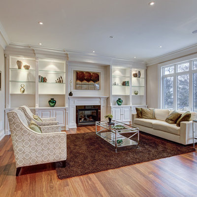 Inspiration for a mid-sized transitional formal and open concept medium tone wood floor and brown floor living room remodel in Toronto with beige walls, a standard fireplace, no tv and a stone fireplace