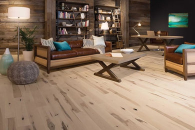 Living room - mid-sized rustic formal and loft-style light wood floor living room idea in Miami with black walls