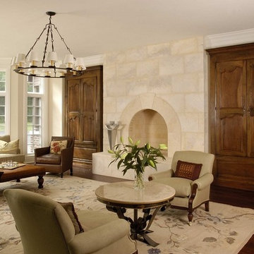 Floor to Ceiling Limestone Fireplace Flanked by Knotty Cherry Armoires