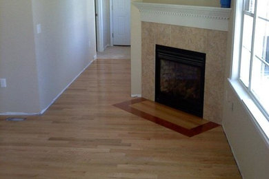 Mid-sized elegant light wood floor living room photo in Indianapolis with beige walls, a standard fireplace and a tile fireplace