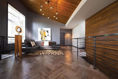 Example of a large trendy formal and open concept medium tone wood floor living room design in Milwaukee with gray walls, no fireplace and no tv