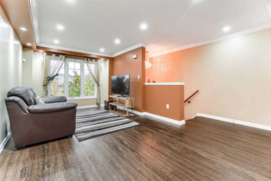 Vinyl floor and brown floor living room photo in Toronto
