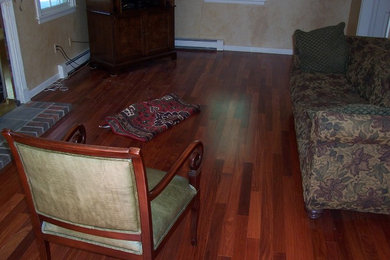 Example of a small classic enclosed medium tone wood floor and brown floor living room design in Boston with beige walls, no fireplace and no tv