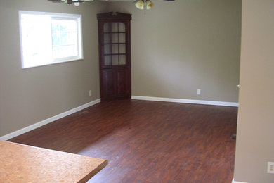 Living room - mid-sized formal and enclosed medium tone wood floor living room idea in Other with beige walls and no fireplace